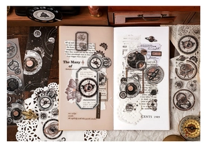 Detail of vintage astronomical PET stickers featuring gears and planets for scrapbooking