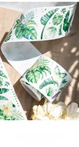 Detail of tropical leaf and butterfly decorative washi tape for DIY scrapbooking journaling