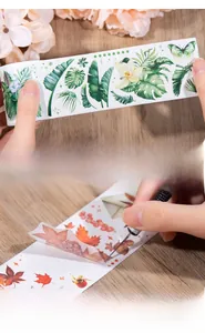 Detail of natural leaf stickers showing easy peeling and manual cutting on wooden table