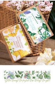 Macro detail of leaf-themed scrapbooking tags with strings and botanical illustrations