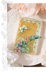 Macro shot of glittery gold tape featuring leaf motifs, butterflies, and lace detail