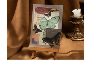Detail of vintage scrapbooking paper featuring butterflies on a small wooden easel stand