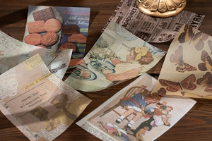 Detailed flat lay of 100 vintage decorative paper sheets for scrapbooking and journaling