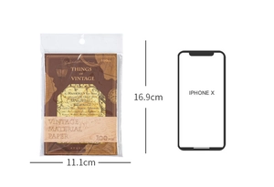 Detail view of vintage scrapbooking paper set 100pcs with iPhone X size comparison