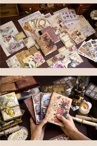 Detailed view of vintage scrapbook kit featuring floral stickers, cards, and mini notebook