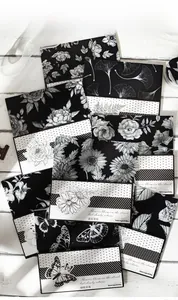 Macro detail of monochrome floral scrapbooking paper with botanical butterfly and daisy patterns