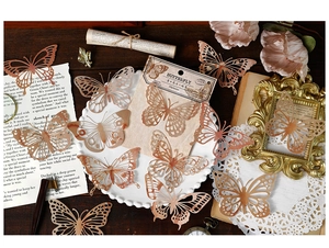 Close-up of vintage laser-cut butterfly lace paper on dark wood for DIY scrapbooking