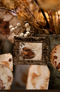Detail of vintage embossed photo frame with baroque floral patterns and coffee illustration