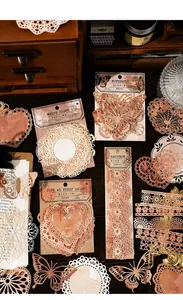 Macro view of vintage lace paper scraps and butterfly deco assets for DIY scrapbooking