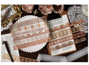 Detailed view of vintage hollow lace border stickers for scrapbooking in metallic rose gold