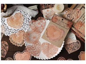 Macro shot of 10-piece cinnamon peach hollow lace paper heart for DIY journaling