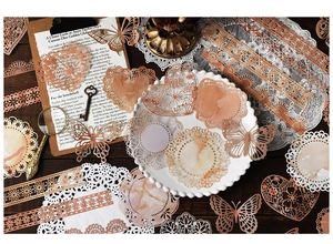 Macro shot of vintage lace paper scraps and butterfly cutouts on a wooden table