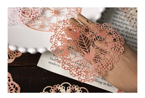 Detailed view of intricate lace heart and floral hollow stickers for scrapbooking