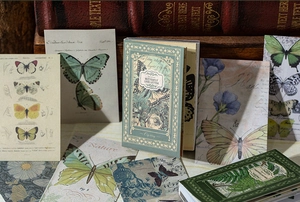 Macro detail of vintage butterfly scrapbooking paper pack with botanical art illustrations