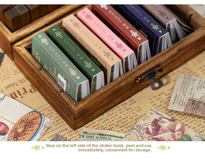 Close-up of vintage aesthetic scrapbooking sticker books neatly arranged in a wooden box