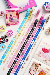 Macro detail of decorative washi tapes with cute patterns and artistic English slogans
