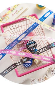 Close-up of cute washi tape with strawberry and cake patterns on a pink basket