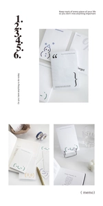 Detailed view of minimalist memo pads with various symbols and inspirational phrases