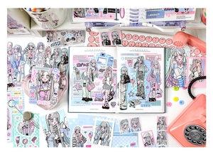 Flat lay of anime girl scrapbooking stickers and cards in pink and blue tones