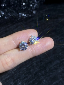 Close-up of S925 sterling silver moissanite stud earrings with brilliant fire and 3-prong setting
