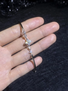 Macro detail of S925 silver four-leaf clover bracelet with sparkling small stones