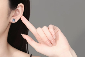 Close-up of S925 sterling silver moissanite stud earring with classic six-prong setting