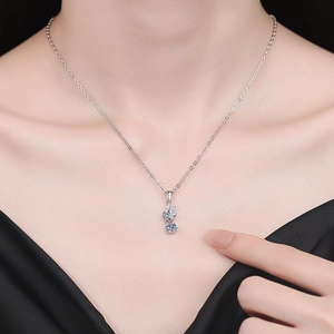 Elegant S925 sterling silver moissanite snowflake necklace on a model wearing black V-neck
