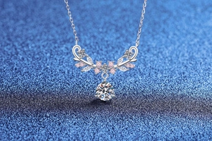 Macro shot of 925 silver necklace featuring deer antler design with pink zircons