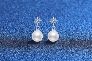 Close-up of S925 silver star earrings with round moissanite and white shell pearls