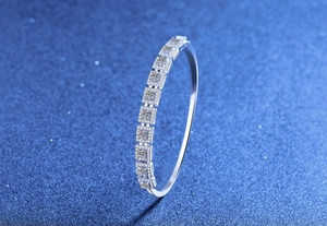 Macro shot of S925 silver bangle featuring square cluster Moissanite stones on a blue base
