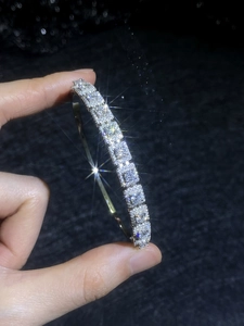 Macro detail of S925 silver bracelet with sparkling moissanite stones and fine claw setting