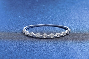 Macro detail of a 925 sterling silver ring with 9 round brilliant-cut moissanite stones