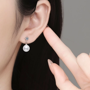 Elegant S925 silver star pearl earrings with blue gemstone on female model