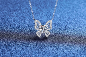 Macro shot of 1 carat moissanite butterfly pendant in S925 sterling silver with pavé setting