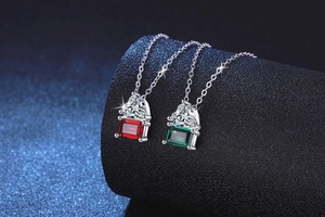 Detail of S925 silver necklaces with heart and rectangular cut emerald and ruby stones