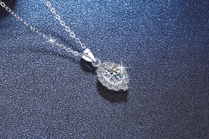 Macro del ciondolo ovale con alone di diamanti scintillanti su catena d'argento S925