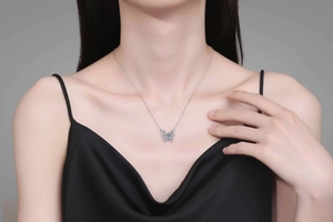 Detail of butterfly necklace with light blue stone on 925 sterling silver chain