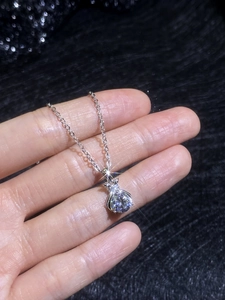 Macro detail of S925 sterling silver necklace with a brilliant moissanite pendant
