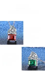 Macro shot of silver necklaces featuring emerald and ruby square pendants with prong setting