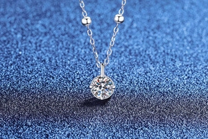 Macro detail of D color moissanite necklace with s925 silver four-claw setting