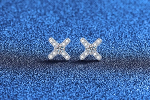 Macro shot of S925 sterling silver X-shape stud earrings with brilliant moissanite stones