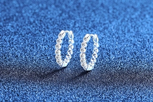 Macro shot of S925 sterling silver hoop earrings with a row of sparkling moissanite stones