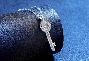 Macro shot of S925 sterling silver key necklace pendant with sparkling moissanite stones