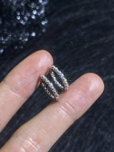 Close-up of S925 sterling silver huggie earrings with sparkling moissanite pave setting