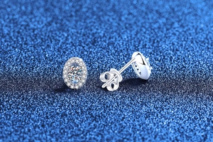 Macro detail of oval halo moissanite earrings in S925 sterling silver with secure backings