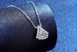Close-up of snowflake pendant with one-carat moissanite and intricate pavé setting
