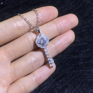Handheld view of S925 sterling silver key pendant necklace with moissanite pavé stones