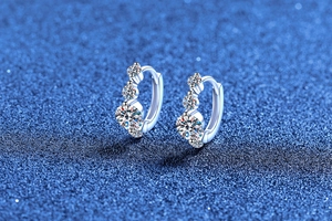 Close-up of S925 sterling silver hoop earrings with round moissanite in curved setting