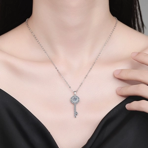 Elegant S925 sterling silver key necklace with 0.5 carat moissanite on a female model