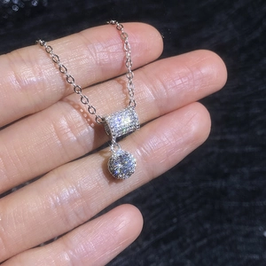 Moissanite pendant necklace with micro-paved cylinder and sparkling main diamond stone